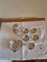 Group shot showing heart dish, shaker, five salts with ruler for scale