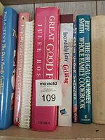 Shelf section with major titles including Great Good Food, Incredibly Easy Grilling, Apple Cider Vinegar, Frugal Gourmet