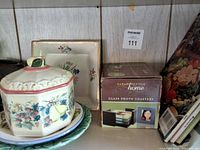 Shelf section with china pieces and boxed photo coasters