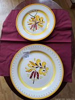 Platter and tidbit plate front views showing pattern and handle