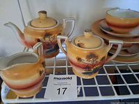 Teapot, sugar bowl, creamer showing Windmill pattern and backstamp tag