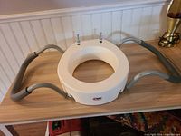 Full view of Carex raised toilet seat with grey side handles