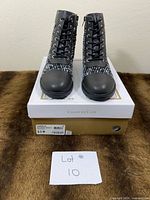 Pair of boots on top of original Charter Club box showing front view