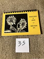 Front cover showing title, sunflower block print and comb binding