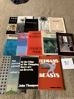 All 13 poetry paperbacks laid out on carpet