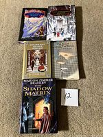 All five books spread out on carpet