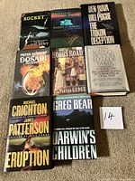 All eight book fronts displayed on carpet