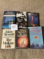 Group shot of five Mary Stewart hardcovers and King Arthur DVD
