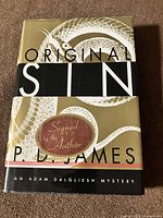 Front of dust-jacketed hardcover showing title and signed sticker