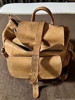 Front view showing flap, front pocket and buckle