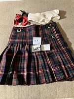 Full view of tartan kilt with accessories arranged on top