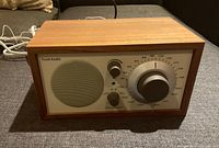 Front view showing speaker grille, control knobs and tuning dial