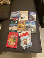 All nine guide books laid out on sofa