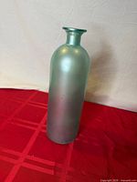 Full view of frosted green glass vase standing upright