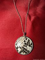 Front view of necklace displaying pendant pattern and chain