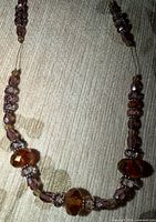 Close view of brown and clear crystal beads on necklace