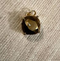 Front view showing brown crystal in gold-tone setting