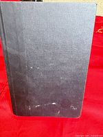 Front view of black hardcover boards showing surface wear