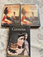 Three DVD cases arranged on surface showing front covers