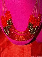 Front view showing layered red, orange and brown faceted beads