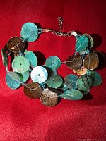 Front view showing shell disc colors and multistrand design