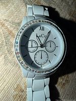 Front view of L&Co watch showing dial and crystal bezel