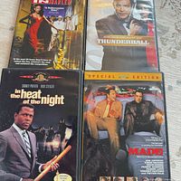 Four DVD cases laid out: Thunderball, unidentified title, In the Heat of the Night, Made