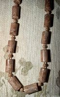 Close view of rectangular and round pink stone beads