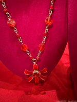 Necklace front view on display form showing bead arrangement and pendant