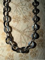 Close-up of disc links highlighting silver-tone finish