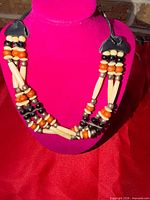 Full view of multi-strand beaded choker on display bust