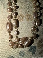 Close-up of beads and gold tone links