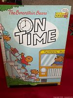 Front cover showing title, clock, bus illustration