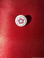 Front view of circular Bicentennial lapel pin showing logo and text