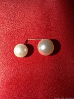 Front view showing both pearls and connecting bar