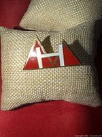 Front view of enamel pin showing design and colors