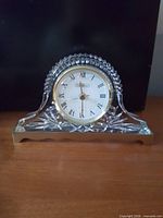 Front view of Collezio crystal-style desk clock showing gold bezel and Roman numeral dial