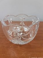 Side view of clear cut crystal bowl showing scalloped rim and floral star motif