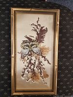 Full view of framed butterfly and dried florals artwork