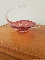 Side view showing pink body and clear curved extension