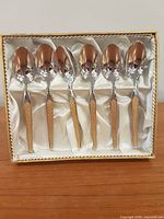 Six gold plated handle spoons in satin-lined box