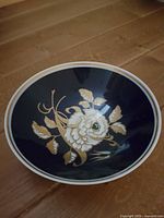 Top view of plate showing cobalt background and raised gold floral design