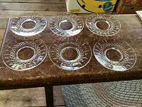 Six matching crystal plates on table