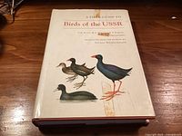 Front cover of hardcover book with title and bird illustrations