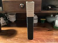 Spine showing paper label and black leather
