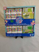 Front of sealed Baby Alive Diaper 'n Snack Refill Pack showing diapers and snack mix packets