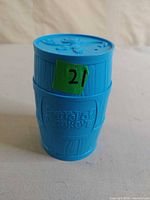 Blue plastic barrel container showing embossed logo