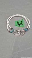 Full view of bracelet showing seed beads, turquoise beads and double heart centerpiece