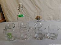 Group shot of bottle, mugs, tulip glass, and rocks glasses