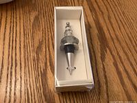 Bottle stopper in original box on wooden surface